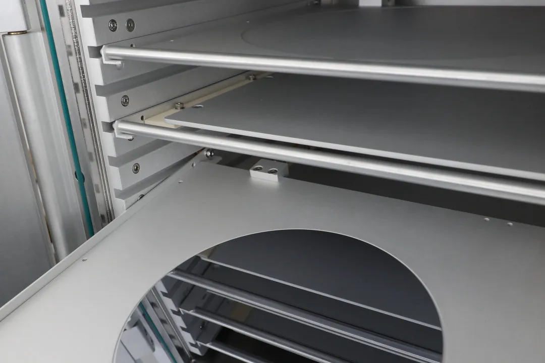 Interior view of a plasma cleaner chamber showing electrode shelves and tray racks