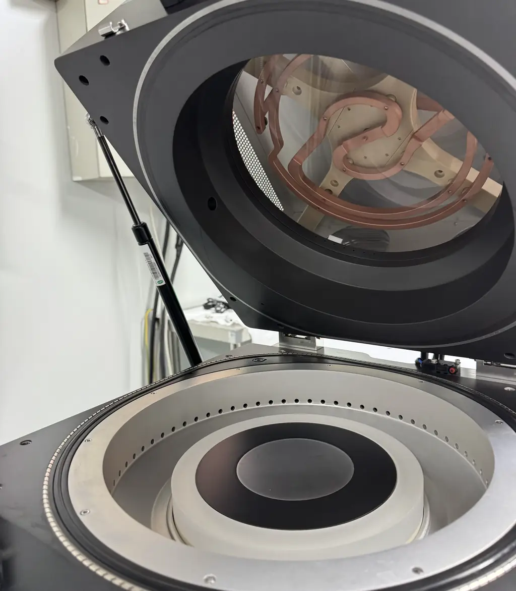 ICP-RIE chamber with the lid raised, showing the planar ICP coil above the dielectric window and the wafer stage below